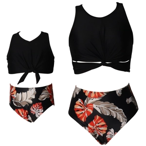 Two-piece family matching bikini sets with black twist knot tops and tropical leaf prints