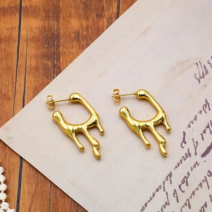 Lava texture gold geometric earrings in liquid metal design on vintage background