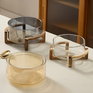 Modern glass salad bowls in amber and grey with minimalist wooden cross stands