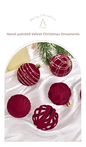Detail of burgundy flocked Christmas balls with gold glitter stars and pine needles deco