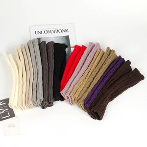 Detail of cable knit pattern and various color options for long fingerless gloves