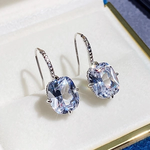 Detailed view of square cushion cut zircon earrings in a premium white gift box