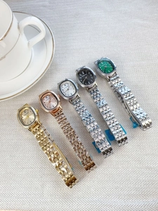 Detailed arrangement of five oval dial quartz watches with metal straps in various colors
