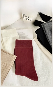 Close-up of premium combed cotton crew socks in multiple colors with fine ribbed texture