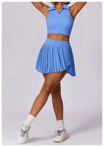 Detail of high-waist pleated tennis skirt and sleeveless polo top in sky blue fabric