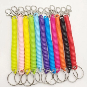 Set of 12 colorful spiral spring plastic keychains with metal clips on white background