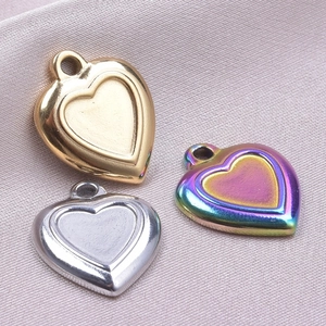 Detailed view of heart-shaped DIY charms in gold, silver, and rainbow 18k plated steel