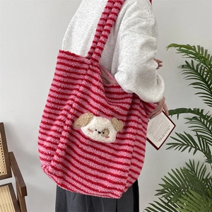 Detail of soft plush striped tote bag with cute 3D cartoon dog patch on a model
