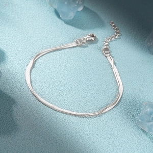 Macro detail of S925 sterling silver stamp on double layer snake chain bracelet