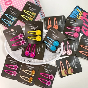 Set of colorful cartoon hair clips for girls including stars and flowers on display card