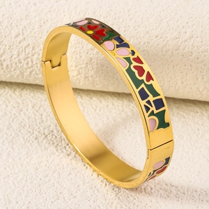 Detailed macro view of 18K gold plated bangle with colorful enamel floral patterns