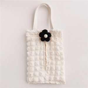 Close-up of white bubble texture fabric car tissue holder with black flower detail
