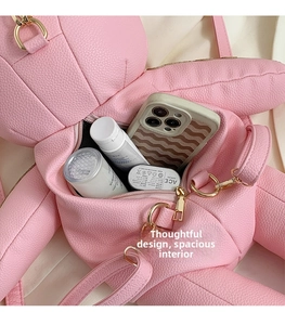 Detail view of pink bear backpack interior showing spacious storage for daily items