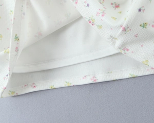Gros plan du tissu en tricot floral avec texture côtelée et ourlet à double couche