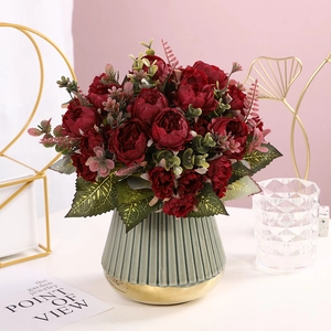 Artificial dark red peonies in a green and gold ceramic vase for modern home decor