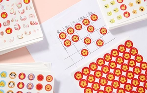 Detail of reward stickers with stars and medals on a handwritten school progress chart