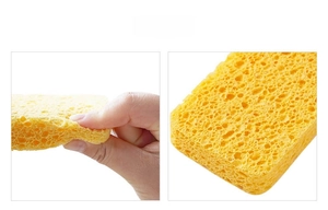 Macro shot of yellow wood pulp sponge showing flexible texture and porous honeycomb structure