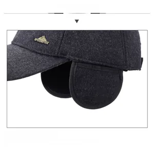 Close-up of winter hat detail with earflaps and metal Sport Spirit logo on grey wool fabric