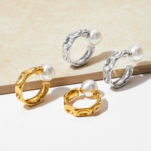 Hammered C-shaped metal earrings in gold and silver finish with large white pearls