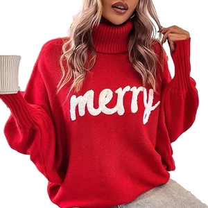Detail of red Christmas turtleneck sweater with white plush 'merry' letter applique