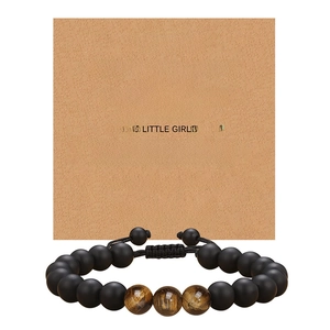 Detail of beaded tiger eye bracelet on kraft gift card for father with heartfelt quote