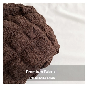 Macro shot of dark brown seersucker fabric with pleated texture and elastic 3D weave