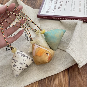 Close-up of traditional zongzi-shaped fabric pendants with elegant tassels and beads
