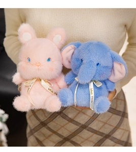 Detail of plush pink rabbit and blue elephant toys with Woody Friends satin ribbons