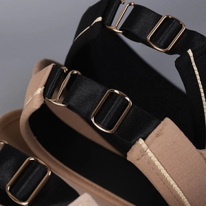 Macro detail of adjustable black elastic strap with golden metal buckle and premium stitching