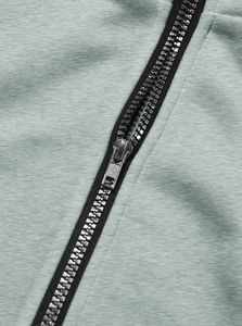 Close-up of premium silver metal zipper and fabric texture on bean green hoodie