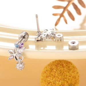 Cute titanium steel butterfly earrings with colorful zircon pendants on decorative background