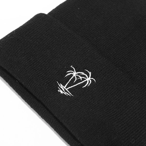 Black knit beanie featuring white embroidered palm tree pattern for winter street fashion