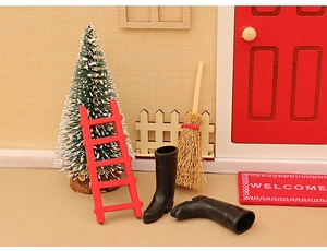 Miniature Christmas set with red ladder, black boots, tiny tree, and welcome mat