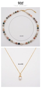 Detail view of colorful beaded necklace and gold pearl pendant with 42+6cm size specs