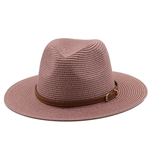 Detail of dusty rose straw hat featuring brown leather band and gold buckle accent