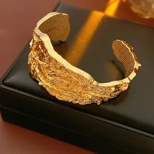 Minimalist gold irregular lava textured open cuff bracelet with metallic ripple effect