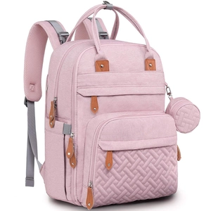 Detail view of pink diaper bag showing woven texture, round pouch and leather zippers