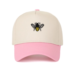 Close-up of the detailed bee embroidery on a color-block five-panel cotton baseball cap