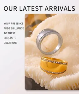 Detail of 18k gold and silver wide titanium rings with crystal pave edges on white coral