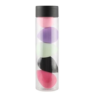 Set of 5 colorful teardrop beauty blenders in a clear cylindrical storage jar with black cap