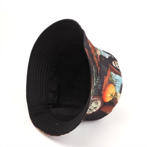 Detail of Halloween bucket hat featuring skull and pumpkin prints with black lining