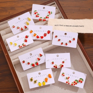 Vibrant fruit stud earrings set featuring watermelon and strawberry on a display card
