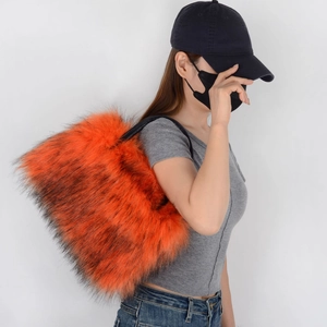 Detail shot of fluffy orange faux fur tote bag with stylish black shoulder straps