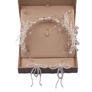 Elegant bridal jewelry set with pearl floral headband and matching bow earrings
