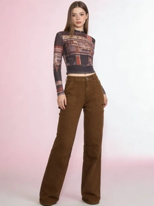 Detail of high-waist brown utility pants with vintage finish and multiple cargo pockets