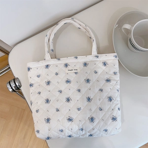 Detailed close-up of quilted floral tote bag fabric with simple wish fabric label