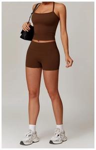 Detailed close-up of brown brushed yoga tank top and high waist shorts with sleek finish