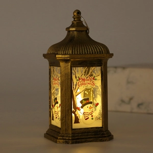 Detail of vintage bronze Christmas lantern with LED light and snowman pattern