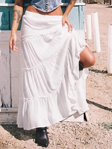 White bohemian tiered maxi skirt with layered ruffles and long flowy A-line silhouette
