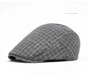 Detail shot of grey plaid flat cap showing premium fine grid texture and stitch work
